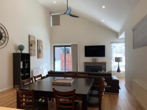 a living room with a table and a couch at Keystone in Dinner Plain