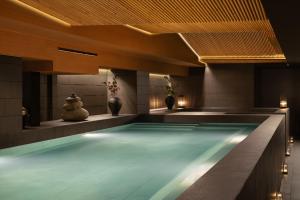 a swimming pool in a hotel with lights on it at The Auberg Collection Hotel in Ho Chi Minh City