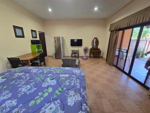 a bedroom with a bed and a desk and a television at Your space surrounded by Nature in Ban Mai Salae