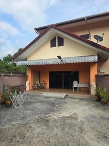 a house with a garage with bikes parked in it at Your space surrounded by Nature in Ban Mai Salae