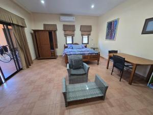 a bedroom with a bed and a table and chairs at Your space surrounded by Nature in Ban Mai Salae