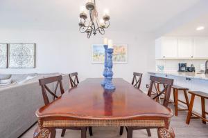 a dining room with a table with a candle on it at Wind Drift 604S condo in Orange Beach