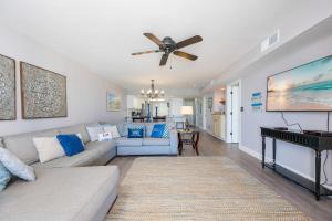 a living room with a couch and a ceiling fan at Wind Drift 604S condo in Orange Beach +59 photos