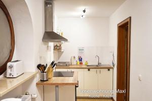 a kitchen with a sink and a counter top at Ferienwohnung Maxl in Schwangau +3 photos