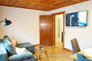 a living room with a couch and a flat screen tv at Ferienwohnung Maxl in Schwangau