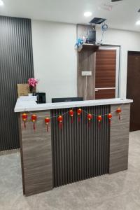 a kitchen with a counter with red flowers on it at Cameron Green Inn Hotel in Brinchang
