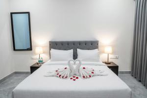 a bedroom with a bed with two swans on it at The Stripes Ranthambore in Sawāi Mādhopur
