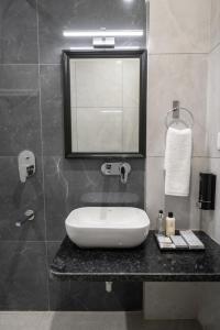 a bathroom with a white sink and a window at The Stripes Ranthambore in Sawāi Mādhopur