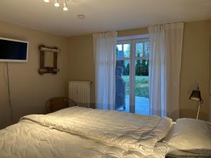 a bedroom with a bed and a sliding glass door at Seepferdchen in Timmendorfer Strand