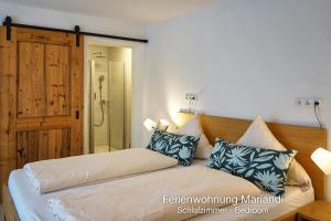 a bedroom with a bed and a glass shower at Ferienwohnung Mariandl in Schwangau