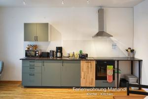 a kitchen with a stove and a counter top at Ferienwohnung Mariandl in Schwangau