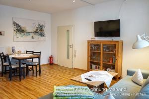 a living room with a table and a couch at Ferienwohnung Mariandl in Schwangau +3 photos