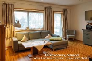 a living room with a couch and a table at Ferienwohnung Mariandl in Schwangau