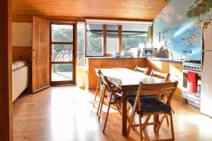 a kitchen with a table and chairs in a room at Georgina's place, Kangaroo Island in Brown Beach +12 photos