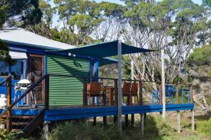 a blue and green house with a blue roof at Georgina's place, Kangaroo Island in Brown Beach