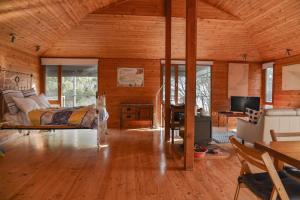 a large room with a bed and a living room at Georgina's place, Kangaroo Island in Brown Beach