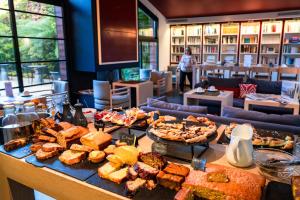 a buffet with many different types of food on a table at Hotel Villa Koegui Biarritz in Biarritz