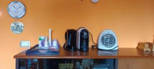 a wooden shelf with a heater and a fan on it at Chalet Nautilus in San Mango Piemonte