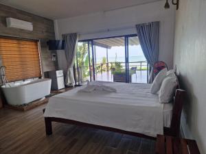 a bedroom with a bed and a bath tub and a bathroom at Butterfly Rose Beach Resort Phú Quốc Francophone in Phú Quốc +151 photos