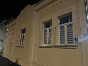 a building with two windows on the side of it at BLANK apartman u centru in Bjelovar