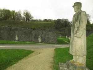 a statue of a man standing on a rock at Les Victoriennes in Verdun-sur-Meuse