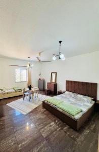 a bedroom with a large bed and a table at Farno Hostel in Muscat