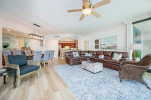 a living room with a couch and a dining room at Phoenix on the Bay 1309 in Orange Beach +46 photos