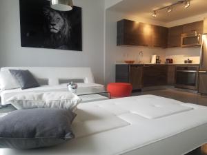 a living room with two beds and a kitchen at Downtown Miami Deluxe Apartment in Miami