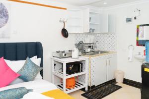 a small kitchen with a sink and a couch at Nelly fully furnished studios in Naivasha