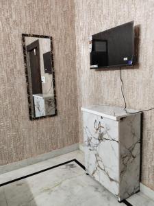 a bathroom with a sink and a mirror at Hotel Blue Heaven in Karnal
