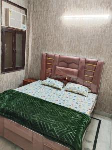 a bed with two pillows on it in a room at Hotel Blue Heaven in Karnal