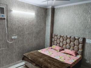 a bedroom with a bed and a shower at Hotel Blue Heaven in Karnal +2 photos