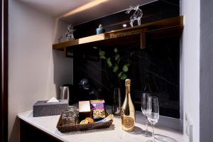 a counter with a bottle of champagne and wine glasses at THE MOMENT, Chiang Mai in Chiang Mai +67 photos