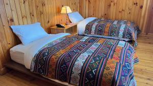 a bedroom with a bed and a lamp on a table at Apartment in Thimphu