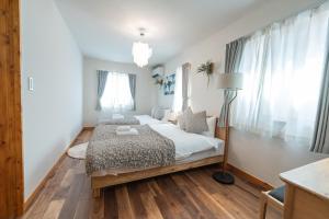a bedroom with a bed and a lamp in it at Miyako Island Breeze in Miyako-jima