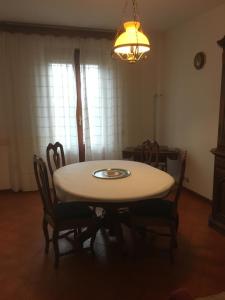 a dining room table with chairs and a light at Podere Telesforo in Acquapendente