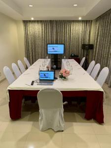 a long table with a laptop on it in a room at S Tara Grand in Suratthani