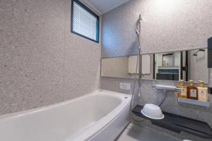 a bathroom with a white tub and a toilet at Miyako Island Breeze in Miyako-jima +31 photos