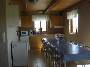 a kitchen with a long table and chairs in it at Hagestad 47 in Löderup