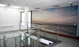 a mural of the ocean on a cruise ship at Apart Morze apartamenty Vento in Władysławowo