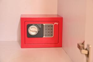 a red box with a remote control on a wall at Hotel Pinaka in Pratāpgarh