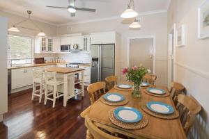 a kitchen and dining room with a table and chairs at Sea La Vie in Busselton