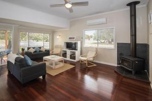a living room with a couch and a fireplace at Sea La Vie in Busselton