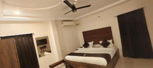 a bedroom with a bed with a ceiling fan at HOTEL classic in Visakhapatnam