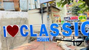 a sign for a hotel in a city at HOTEL classic in Visakhapatnam +3 photos
