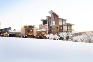 a group of buildings in a city with snow at Abom Hotel in Mount Buller