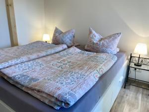 a bedroom with a bed with pillows on it at Ferienwohnung Hof Falke in Suderbruch