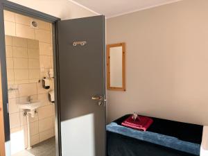 a bathroom with a bed and a sink and a door at Kuremaa Külalistemaja in Kuremaa +45 photos