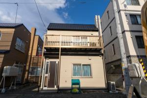 a small house with a balcony on top of it at KitaのHikari in Sapporo