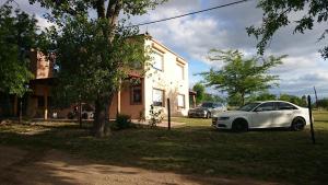 a white car parked in front of a house at Terrazas de Villa Gloria in Villa Giardino